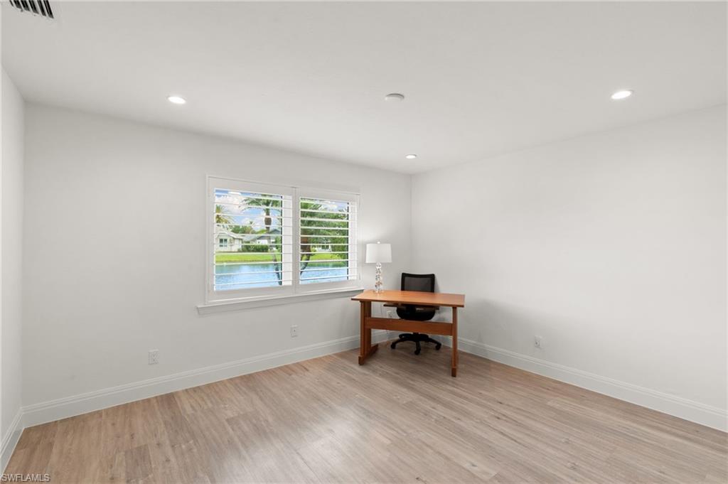 2178 Pinewoods Circle, Unit 25 Naples, FL 34105 - Photo 30 of 45 a view of work space with wooden floor and furniture
