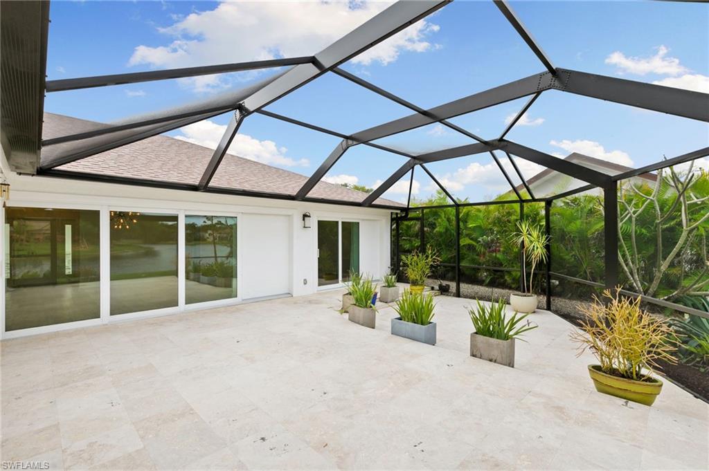 2178 Pinewoods Circle, Unit 25 Naples, FL 34105 - Photo 35 of 45 a house view with a seating space and garden view