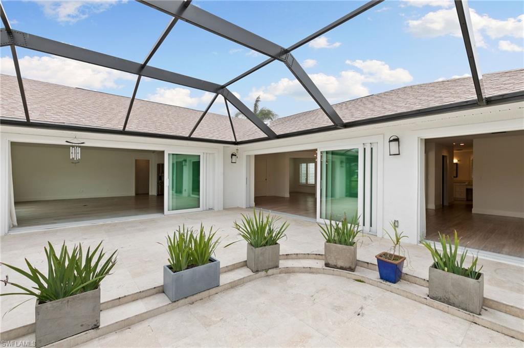 2178 Pinewoods Circle, Unit 25 Naples, FL 34105 - Photo 36 of 45 a front view of a house with outdoor seating
