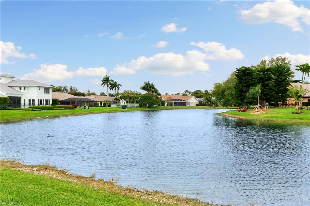2178 Pinewoods Circle, Unit 25 Naples, FL 34105 - Photo 41 of 45 a view of a lake with houses