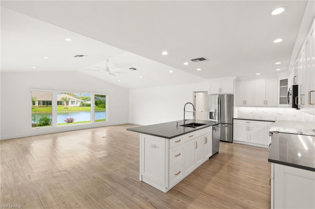 2178 Pinewoods Circle, Unit 25 Naples, FL 34105 - Photo 10 of 45 a kitchen with stainless steel appliances granite countertop a sink and a stove