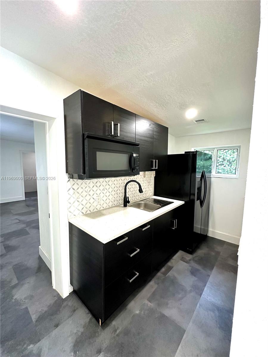 1960 West 63rd Street, Unit EFFICIENCY Hialeah, FL 33012 - Photo 4 of 12 a spacious bathroom with a double vanity sink and a mirror