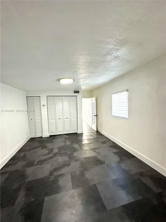 an empty room with windows and pillars in it