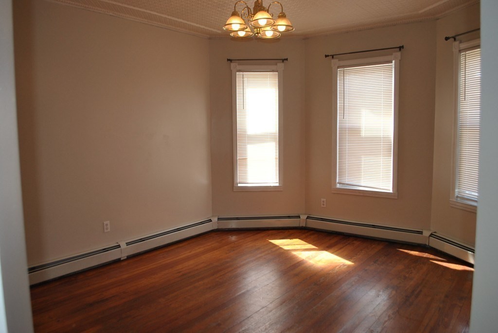 40 I Street, Unit 3 Boston, MA 02127 - Photo 5 of 11 an empty room with wooden floor and windows