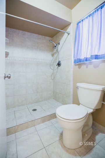 1025 Scott Street Ridgecrest, CA 93555 - Photo 15 of 29 a bathroom with a toilet and a shower