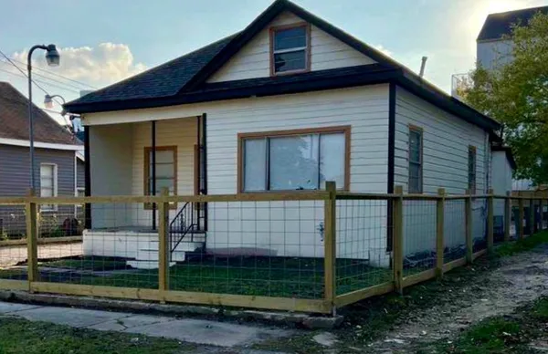 a front view of a house with garden