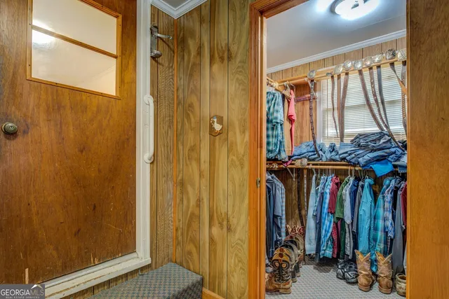 a view of walk in closet with clothes