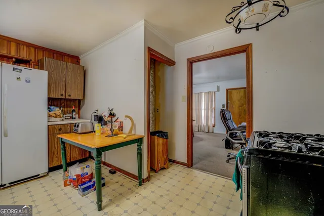 a room with furniture a rug and white walls