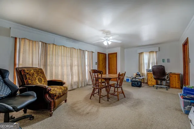 a view of a livingroom with workspace and a window