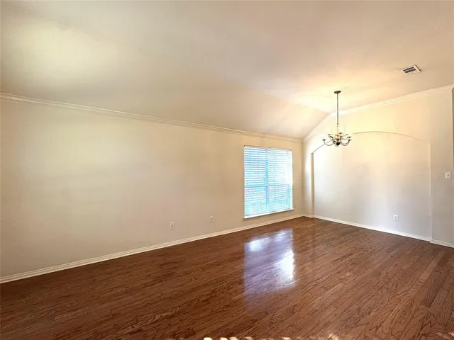 a view of a room with wooden floor and windows