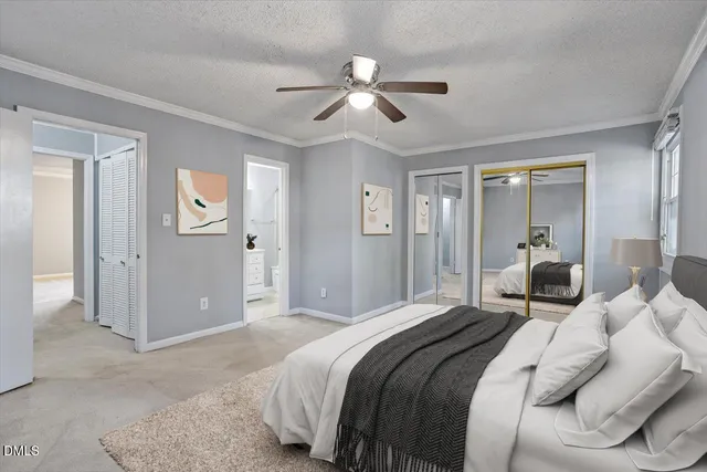 a bedroom with a large bed and a chandelier