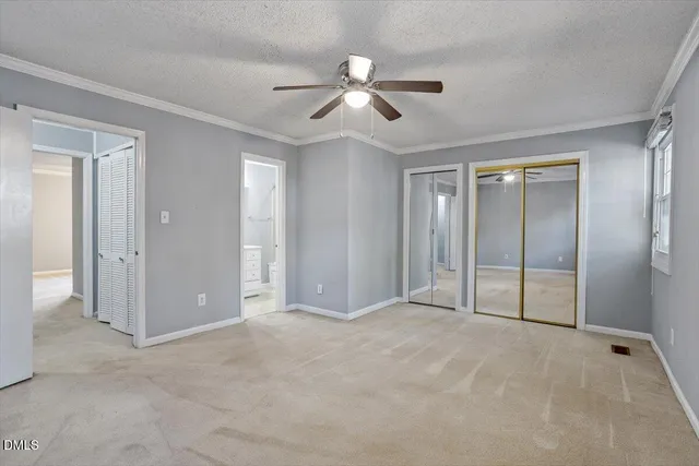 a view of an empty room with a ceiling fan