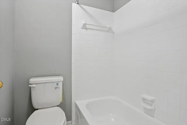 a white toilet sitting next to a white sink