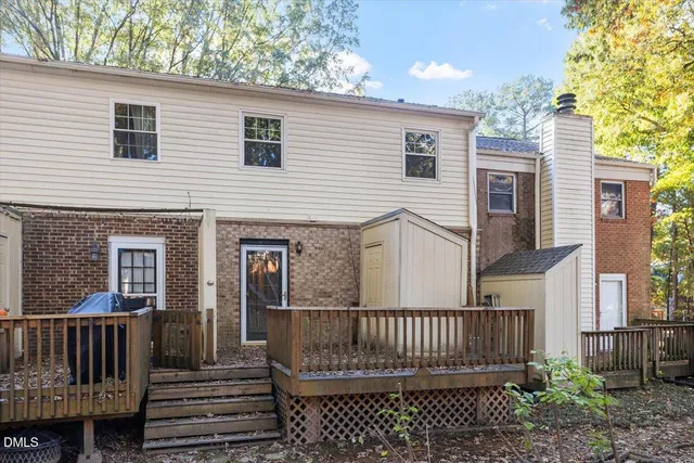 a view of a house with wooden fence