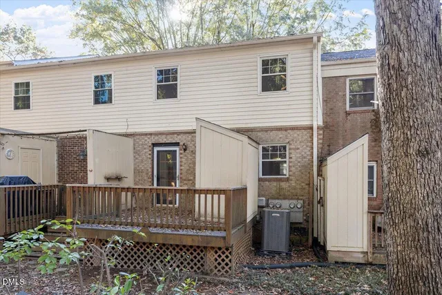 a view of a house with a wooden fence