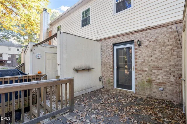 a view of a house with a small deck