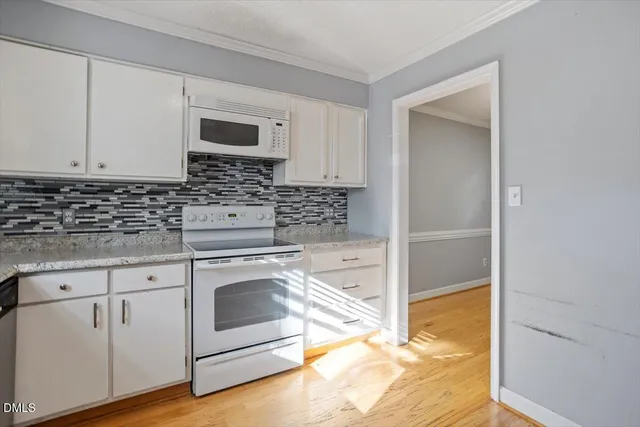 a kitchen with stainless steel appliances granite countertop a stove and a sink