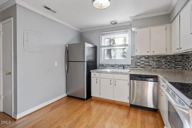 a kitchen with a refrigerator stove and wooden cabinets