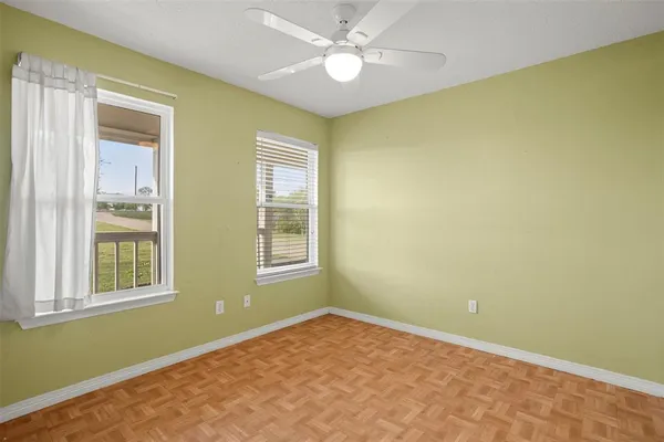 a view of an empty room with a window and closet
