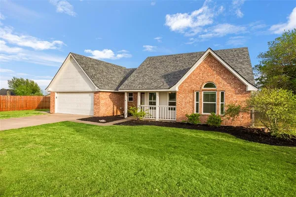 a view of a house with a backyard