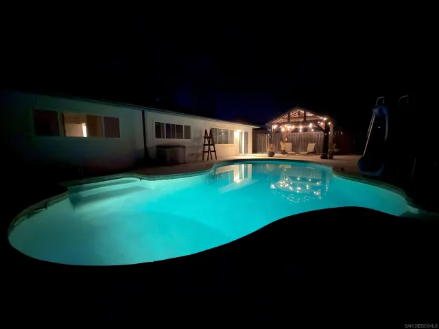 a view of a swimming pool with an outdoor seating