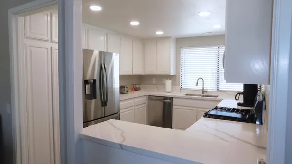 a kitchen with a refrigerator stove and sink