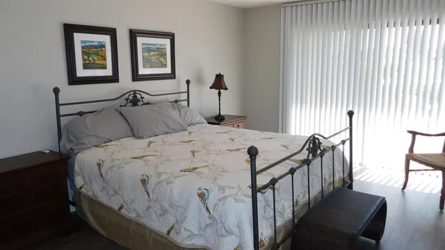 a bedroom with double bed and a window