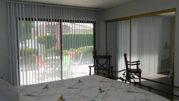 a view of a livingroom with furniture and floor to ceiling window