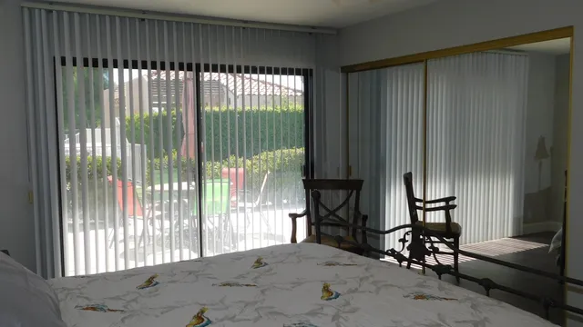 a view of a livingroom with furniture and floor to ceiling window