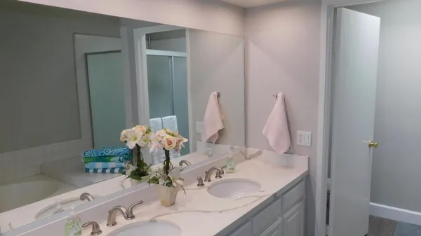 a bathroom with a sink vanity and a mirror