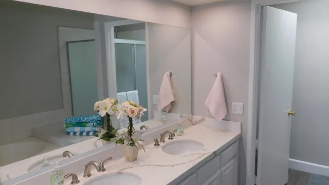a bathroom with a sink vanity and a mirror