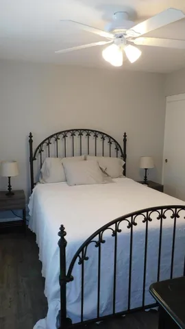 a large bed sitting in a bedroom next to a window