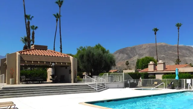 a view of a house with swimming pool and porch with furniture