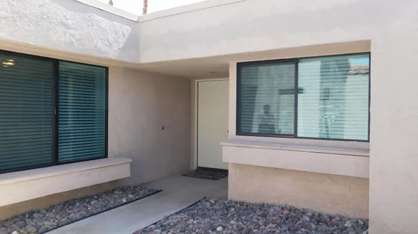 a view of a door and a window