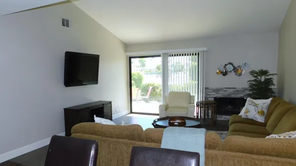 a living room with furniture lamp and a fireplace