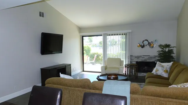 a living room with furniture lamp and a fireplace