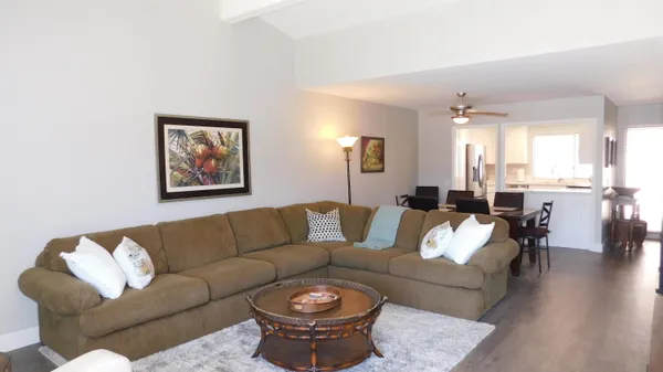 a living room with furniture and wooden floor