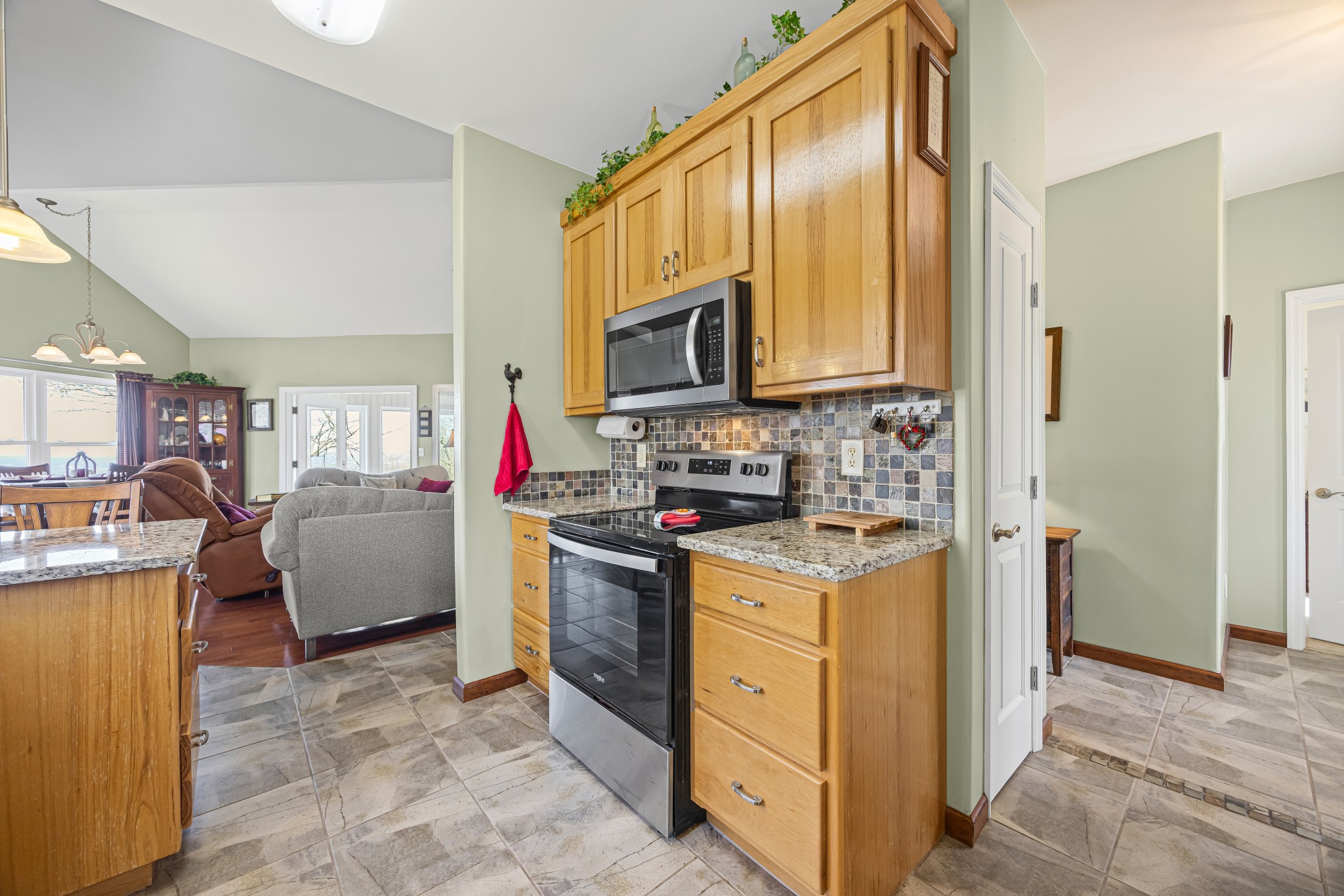 300 Iron Gap Road Belvidere, TN 37306 - Photo 11 of 84 a kitchen with kitchen island granite countertop a stove top oven a sink dishwasher and a refrigerator