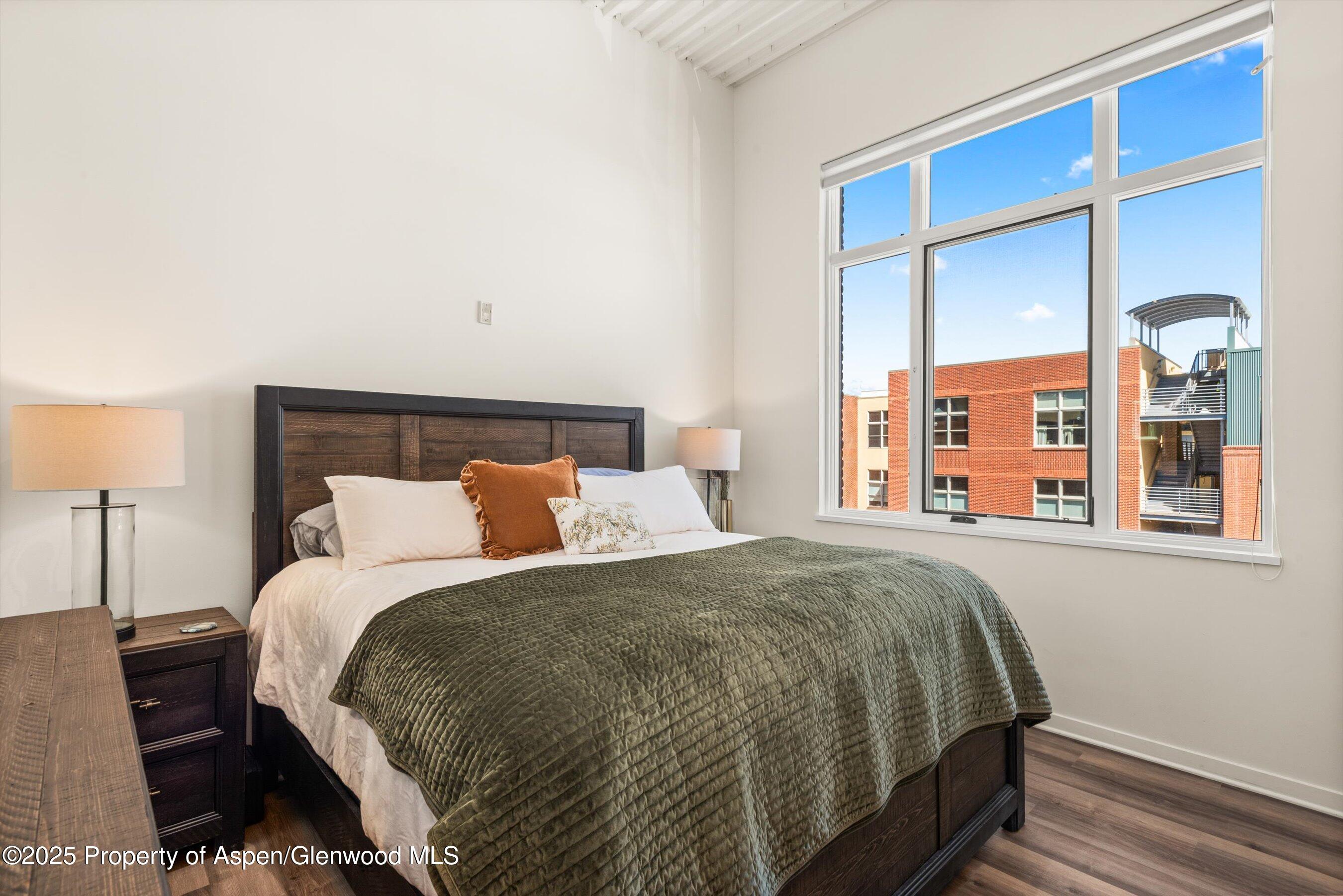 361 Robinson Street, Unit 314 Basalt, CO 81621 - Photo 11 of 17 a bed sitting in a bedroom next to a window