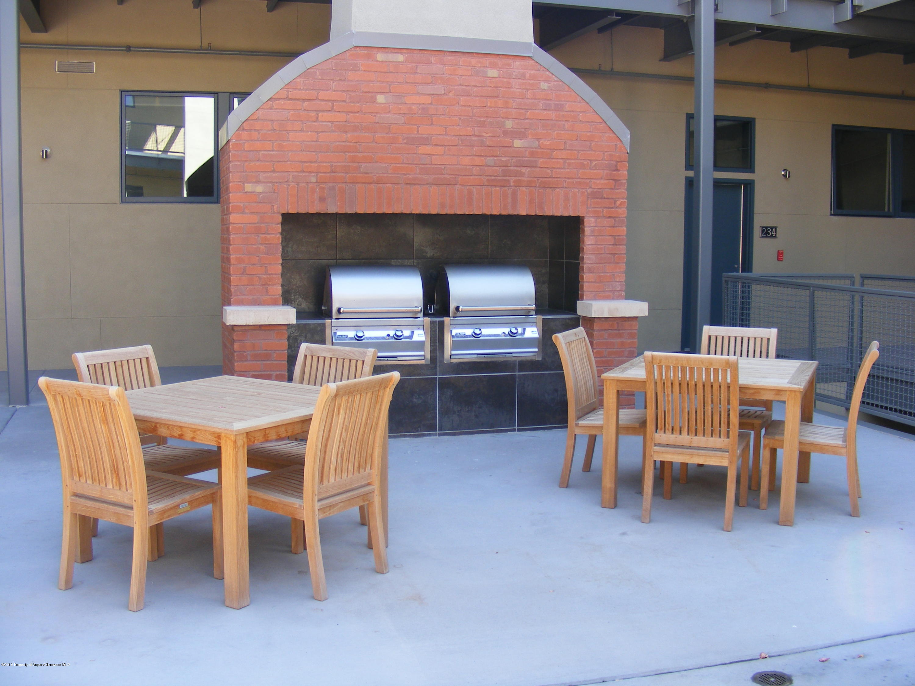 361 Robinson Street, Unit 314 Basalt, CO 81621 - Photo 16 of 17 a dining room with furniture and a fireplace