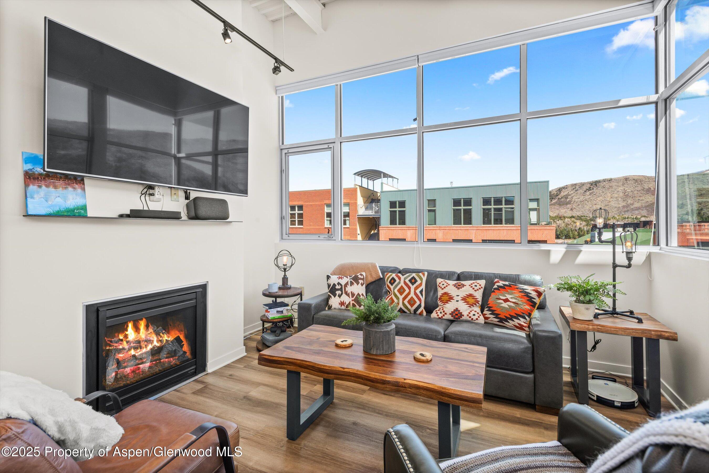361 Robinson Street, Unit 314 Basalt, CO 81621 - Photo 3 of 17 a outdoor living room with furniture a fireplace and a flat screen tv