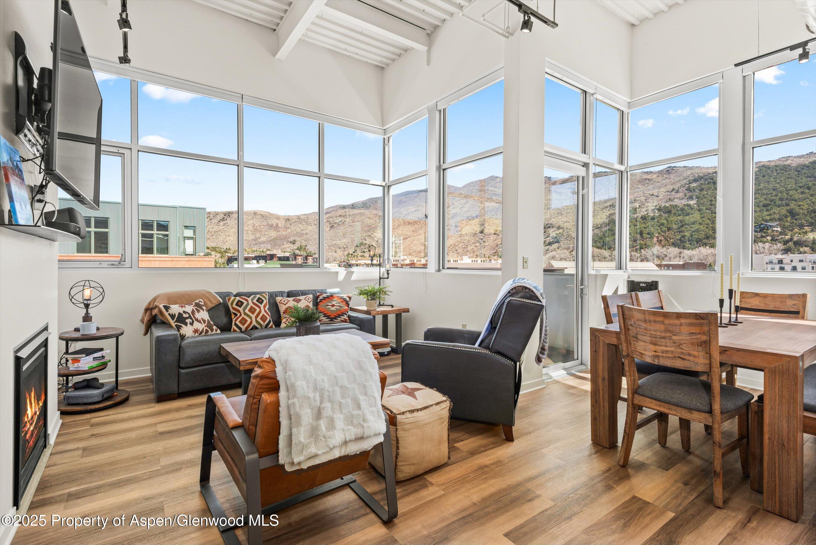 361 Robinson Street, Unit 314 Basalt, CO 81621 - Photo 5 of 17 a living room with furniture a flat screen tv and a large window