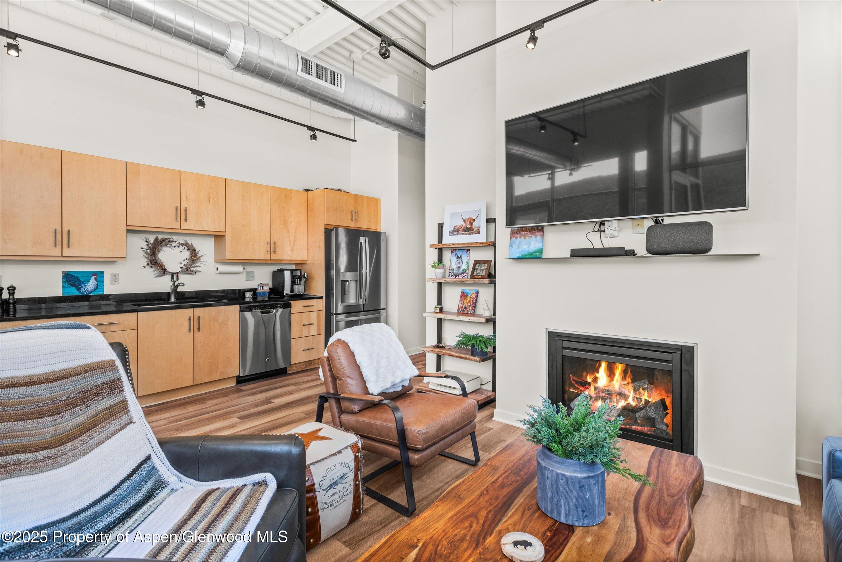 361 Robinson Street, Unit 314 Basalt, CO 81621 - Photo 7 of 17 a living room with furniture fireplace and flat screen tv