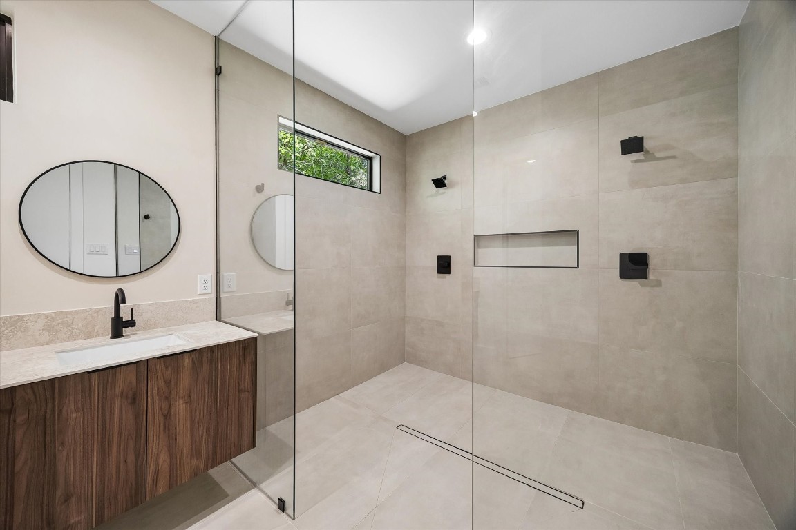 10943 Mockingbird Place Conroe, TX 77385 - Photo 11 of 24 a bathroom with a sink toilet and shower