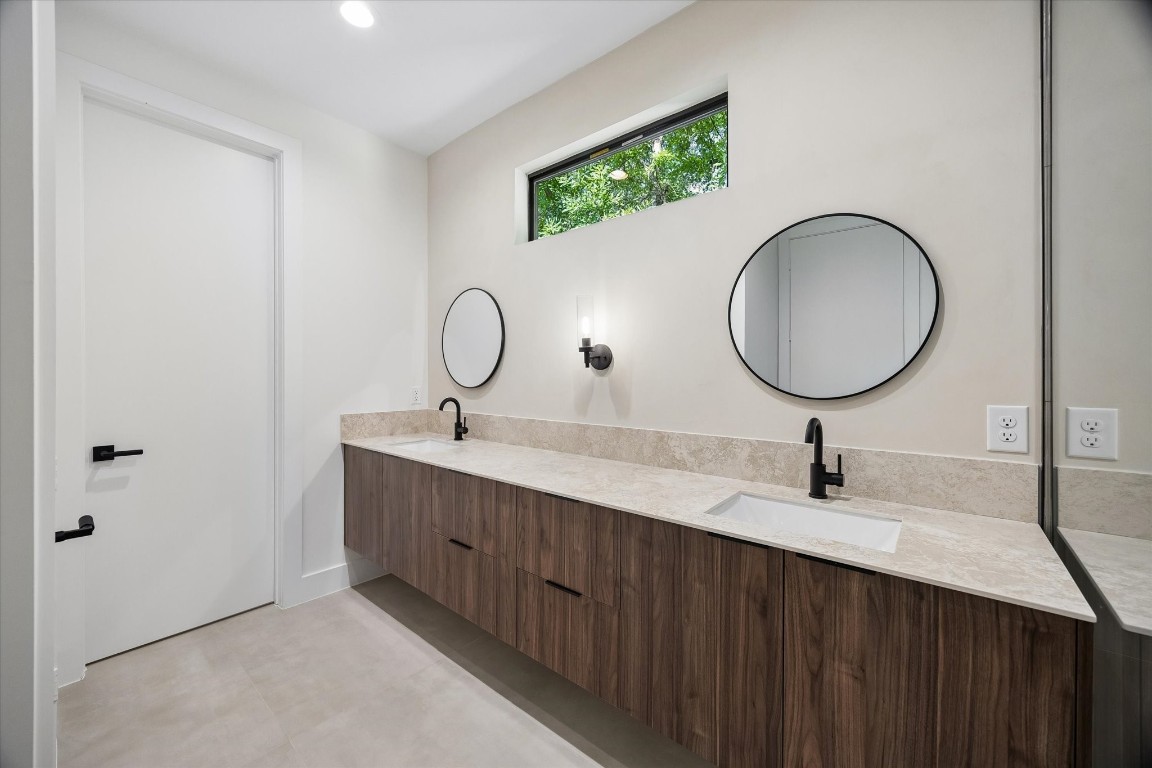 10943 Mockingbird Place Conroe, TX 77385 - Photo 12 of 24 a bathroom with a double vanity sink and a mirror