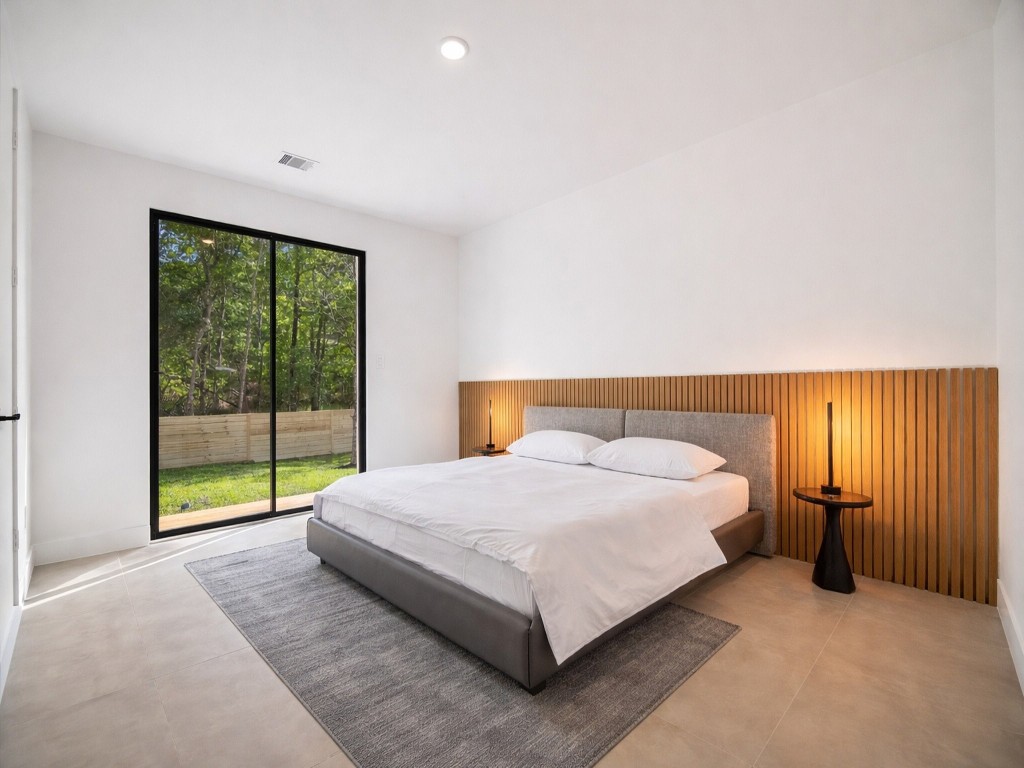 10943 Mockingbird Place Conroe, TX 77385 - Photo 17 of 24 a bedroom with a bed and a large window