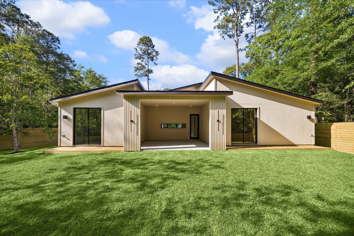 10943 Mockingbird Place Conroe, TX 77385 - Photo 21 of 24 a front view of a house with a yard and garage