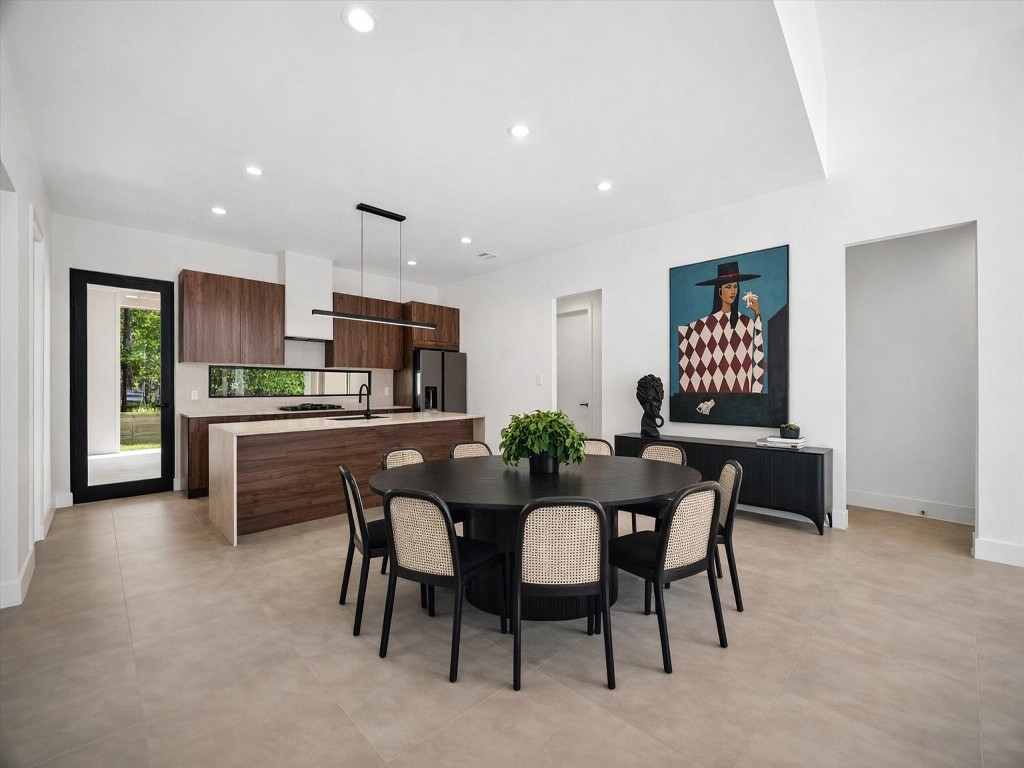 10943 Mockingbird Place Conroe, TX 77385 - Photo 4 of 24 a view of a dining room with furniture and a kitchen