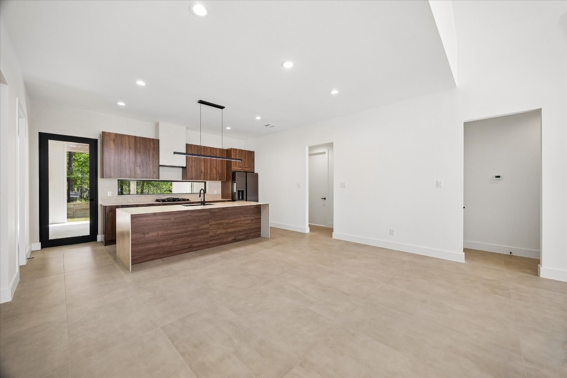 10943 Mockingbird Place Conroe, TX 77385 - Photo 5 of 24 a kitchen with stainless steel appliances granite countertop a refrigerator and a sink