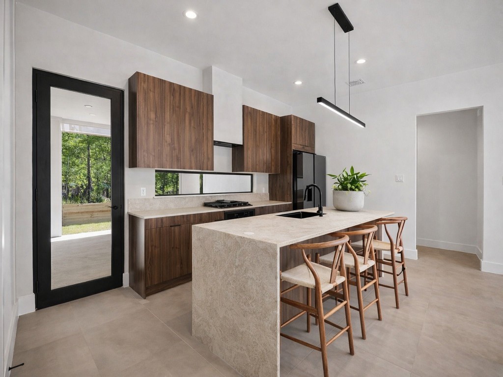 10943 Mockingbird Place Conroe, TX 77385 - Photo 8 of 24 a kitchen with kitchen island a stove a table and chairs in it